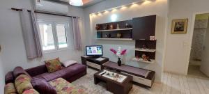 A television and/or entertainment centre at Flora's Boutique Apartment at the heart of Corfu