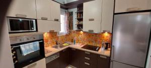 A kitchen or kitchenette at Flora's Boutique Apartment at the heart of Corfu
