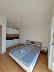 a bedroom with a large bed with blue sheets at Indijano Apartment in Ohrid