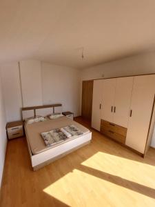 a bedroom with a bed and white cabinets at Indijano Apartment in Ohrid