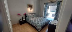 A bed or beds in a room at Flora's Boutique Apartment at the heart of Corfu