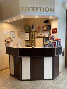 a lobby with a reception counter in a store at Family hotel Deykin in Sunny Beach