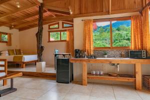 a room with a kitchen with a sink and a bedroom at Rio Chirripo in Rivas
