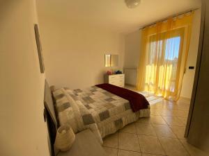 a bedroom with a bed and a window at Casa Iole in Montepulciano