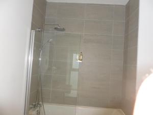 a shower with a glass door in a bathroom at Buckie - 1 Bedroom with ensuite in Wick