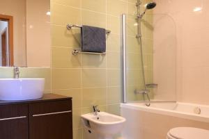 a bathroom with a sink and a toilet and a shower at Panorama Apartment Sagres *Pool* in Sagres