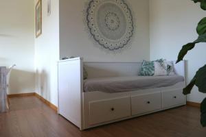 a bed in a room with a white wall at Panorama Apartment Sagres *Pool* in Sagres +26 photos