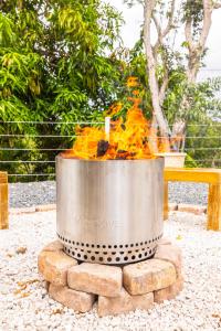 a large metal bucket filled with fire on top of bricks at Bello Amanecer Guest House with Private Pool in Anasco