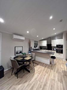 a kitchen and dining room with a table and chairs at Family home in Northampton