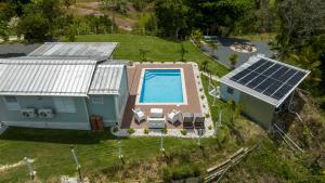 an aerial view of a house with solar panels on it at Bello Amanecer Guest House with Private Pool in Anasco