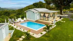 an aerial view of a house with a swimming pool at Bello Amanecer Guest House with Private Pool in Anasco