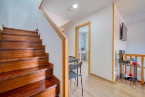 a staircase in a home with a wooden stair case at CASACAFÉ Madrid Pozuelo Estación Private Rooms in Pozuelo de Alarcón