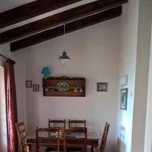 a dining room with a wooden table and chairs at House by the sea in Podaca +49 photos