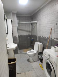 a bathroom with a shower and a toilet and a sink at Stay N play in Istanbul