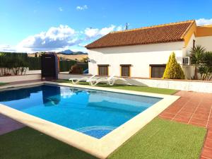 a swimming pool in front of a house at Only4you Country House Perfect location to visit Andalucia in Casabermeja
