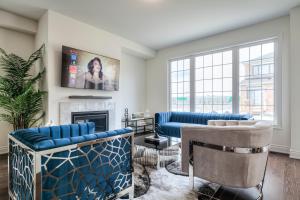 a living room with blue furniture and a fireplace at Masterfully Designed Private Suite in Bradford