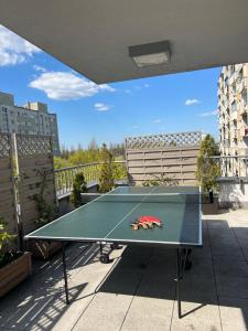 a ping pong table on top of a balcony at Apartament Księcia Janusza in Warsaw