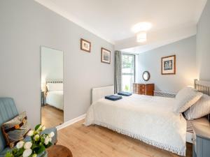 a bedroom with a bed and a mirror at Pennard in Tuckingmill