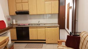 a kitchen with wooden cabinets and a sink at La casetta in Domaso