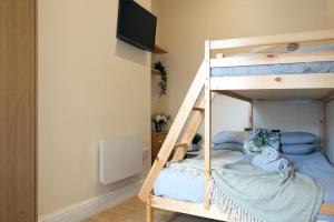 a bunk bed with a television on top of it at LFC Stadium Apartment 2 in Liverpool