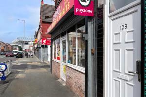 a building with a sign on the side of a street at LFC Stadium Apartment 2 in Liverpool