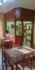 a dining room with a table and some shelves at Apartman Down Town in Sremska Mitrovica