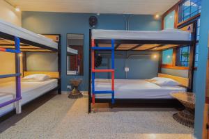 Zimmer mit Etagenbett und 2 Etagenbetten. in der Unterkunft Tambo Hostel in Leticia