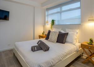 a bedroom with a large bed with two pillows on it at Salt 7 Spacious Luxury in Sorrento walk to the beach in Sorrento