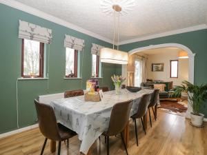 a dining room with a table and chairs at Sandown in Bowness-on-Windermere