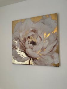 a painting of a white flower on a wall at Luxury Spacious 2 Bedroom Home. in Liverpool