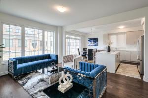 a living room with two blue couches and a kitchen at Your Perfect Getaway Master Bedroom in Bradford