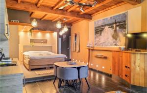 a bedroom with a bed and a table and chairs at 1 Bedroom Stunning Home In Damme in Damme