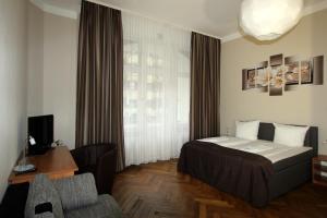 Postel nebo postele na pokoji v ubytování Hotel Elegia am Kurfürstendamm
