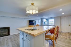 a kitchen with a sink and a table with chairs at Toms River Apartment about 5 Mi to Jersey Shore! in Toms River