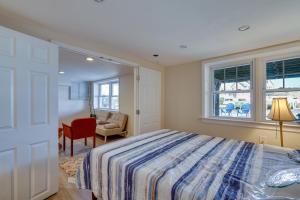 a bedroom with a bed and a chair and a window at Toms River Apartment about 5 Mi to Jersey Shore! in Toms River