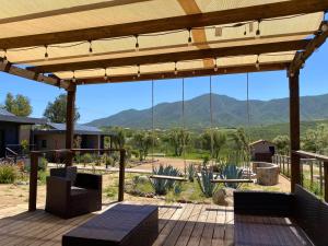 a patio with a view of the mountains at Coquenas del Valle in Valle de Guadalupe