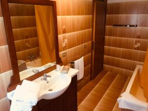 a bathroom with a sink and a mirror at Mo.Da' Apartments in San Marino
