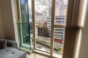 a room with a window with a view of a city at Luxury 2-Bed Croydon Apartment Near Gatwick in Croydon