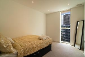 a bedroom with a bed and a large window at Luxury 2-Bed Croydon Apartment Near Gatwick in Croydon