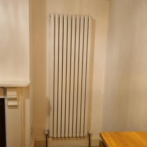 a radiator in the corner of a room at 41 Crawley Road in Luton