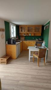 a kitchen with a table and chairs in a room at Apartment Fritali in Tadten