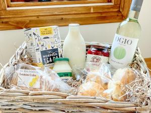 a basket filled with food and a bottle of milk at Little Norfolk Cabin in Neatishead