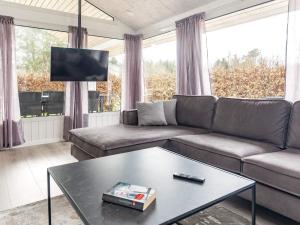 a living room with a couch and a coffee table at Holiday Home Falkevej IV in Terpet