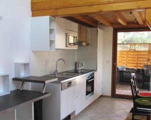 a kitchen with a sink and a counter top at Cozy Villa close to CERN, Geneva Airport, UN in Gex