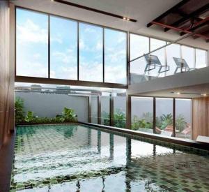 a large swimming pool in a building with windows at Smart loft Bogota - Chico in Bogotá