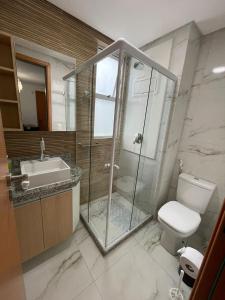 uma casa de banho com um chuveiro, um WC e um lavatório. em MAKARANDUBA BEACH 304 - Piscinas Naturais e Coração de Porto em Porto de Galinhas