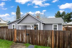 a house behind a wooden fence at Cozy and 3 mins to Tacoma dome. in Tacoma