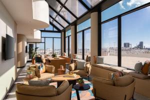 a lobby with couches and tables and large windows at Miami Marriott Biscayne Bay in Miami