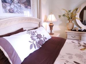 a bedroom with a white bed and a mirror at Poli House Family Villa W/ Pool in Corfu Town