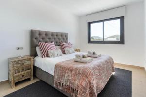 a bedroom with a large bed and a window at Villa Ca Sa Roca en Sant Josep de sa Talaia in Sant Josep de Sa Talaia